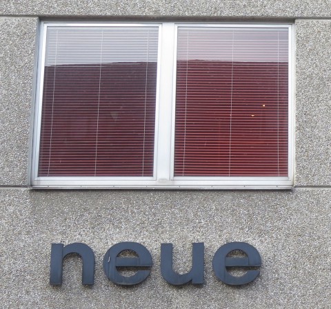 Lettering "neue" ("new") on a Vienna house facade 1960s lettering "neue" ("new", plural) on a Vienna house facade