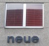  1960s lettering "neue" ("new", plural) on a Vienna house facade